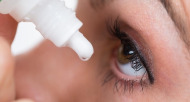 Women dropping eye's liquid on her eye